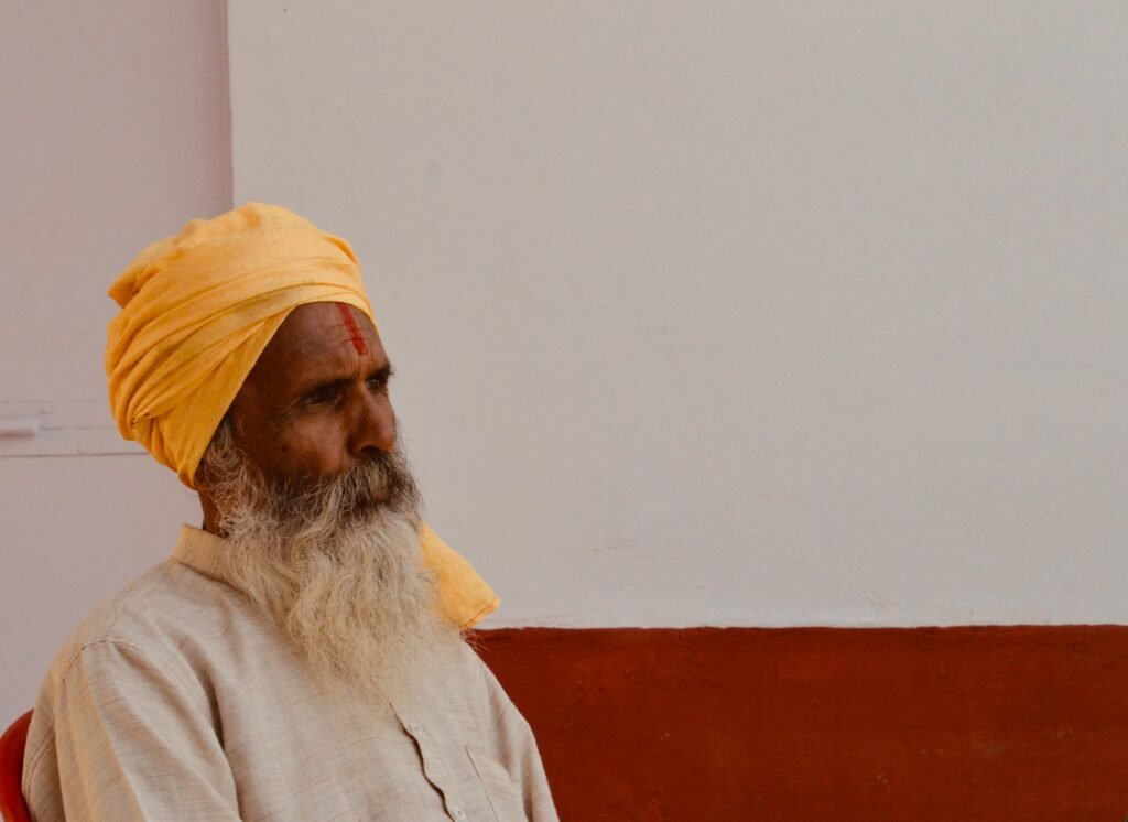 man in white shirt wearing yellow turban